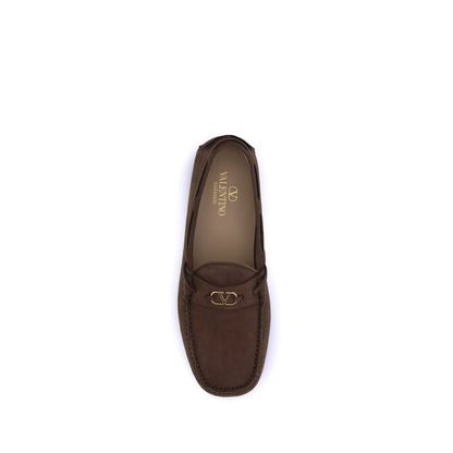 Valentino Garavani Brown Rubber Slip-On Loafers with VLogo plaque and notched sole for elegance and comfort.