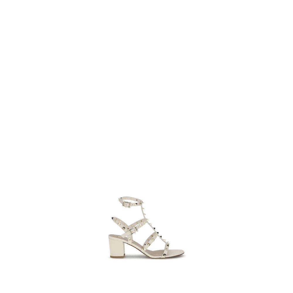 Valentino Garavani Cream Calf Leather Bos Taurus Sandals with Rockstud studs, round toe, and adjustable ankle strap.