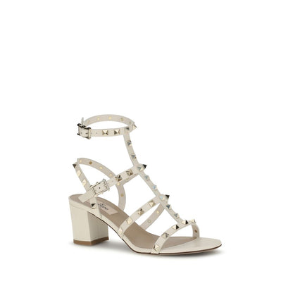 Valentino Garavani Cream Calf Leather Bos Taurus Sandals with Rockstud accents, round toe, and chunky heel for elegant style.