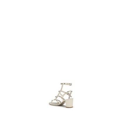 Valentino Garavani Cream Calf Leather Bos Taurus Sandals with Rockstud, round toe, and adjustable ankle strap.
