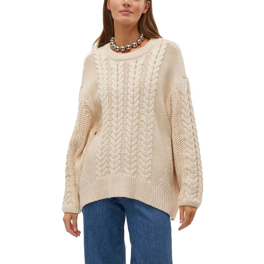 Vero Moda Beige Cotton Sweater with cable-knit design, worn by a woman, featuring a relaxed fit and oversized sleeves. Ideal for colder seasons.