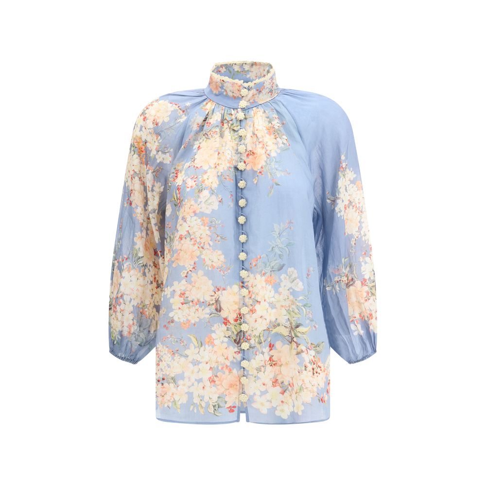 Zimmermann Light Blue Ramie Blouse with floral print, puff sleeves, crochet buttons, and lace neckline detail.